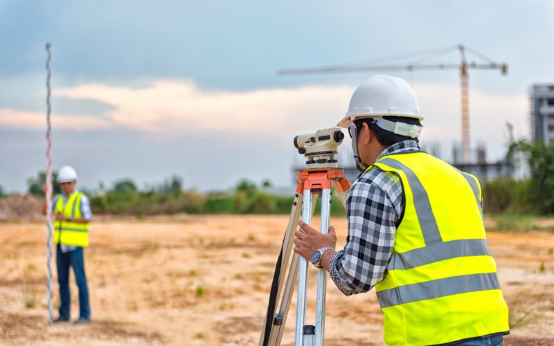 Surveyor equipment. Surveyor’s telescope at construction site or Surveying for making contour plans are a graphical representation of the lay of the land before startup construction work
